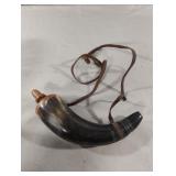Powder horn with a leather strap.