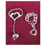 2 Heart themed silver colored bracelets,  one