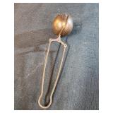 copper tea infuser with a clamp handle