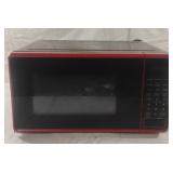 Red microwave. Needs cleaned. Works