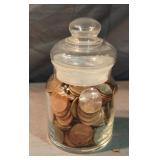 Small jar with pennies with lid