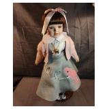 Vintage-style porcelain doll wearing a