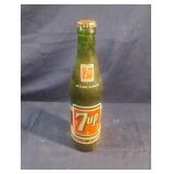 Vintage 7-Up 10 fl oz green glass bottle.
