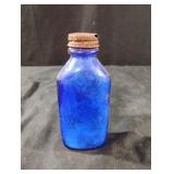 Vintage cobalt blue glass bottle with lid