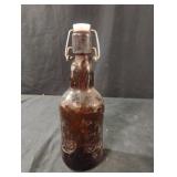 Vintage Grolsch swing-top brown beer bottle.