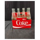 Vintage Coca-Cola 16 oz bottles in a cardboard 8