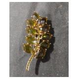 Vintage gold tone and green brooch