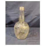 Vintage embossed clear glass bottle from the