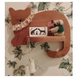 Wooden cat shelf with contents