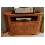Corner wood entertainment center. Contents not