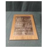 Copper sign in a wood frame