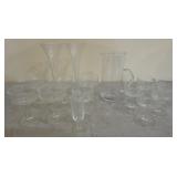 clear glass beverage pitcher,  glasses and