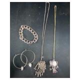 Silver colored bracelet, earrings, and necklaces