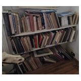 3 shelves of books mostly art books, pottery