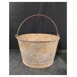 Vintage galvanized metal tub with a swing handle,