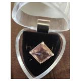 This costume jewelry piece is a large pink stone
