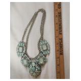 A silver-tone necklace with light turquoise