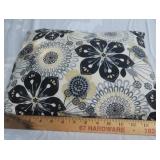 Oblong black and tan pillow