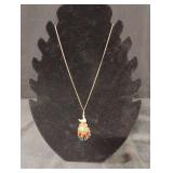 Gold tone peacock medallion charmed necklace