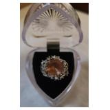 Ring with large peach colored stone in a