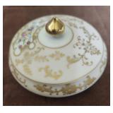 This white porcelain trinket box. Gold scroll
