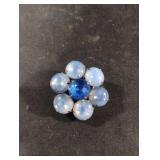 Vintage brooch features a cluster of light blue