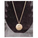 Gold tone sand dollar pendant necklace