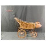 Vintage wicker and wood doll buggy featuring a