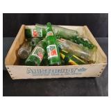 Vintage drink bottles in a wood and cardboard