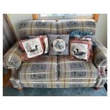 Plaid loveseat and duck throw pillows