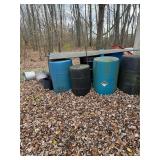 Five plastic 55 gallon barrels