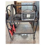 Vintage metal stand on rollers, jumper, cables etc