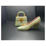 Green purse in high heel shoes, figurines