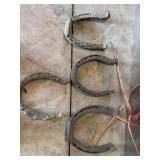 Vintage horse shoes, rope, wood slab etc