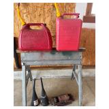 Jack, sawhorse, gas cans, and funnels