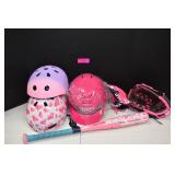 Three Girl's Helmets,Two Gloves And A Bat