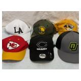 Six sports team ball caps. All look new.