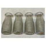 Four 5 inch milk bottles