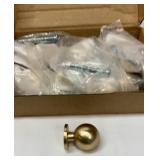 Ten brushed brass cabinet knobs with screws