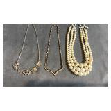 Collection of choker necklaces.  White pearl is