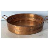 hammered copper tray with brass handles.
