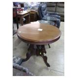 Tri leg circular end table.Ornately cut& carved