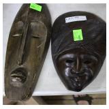 Two wood carved facemasks