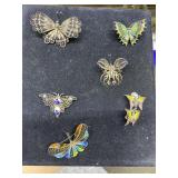 Five butterfly pins & a pair of clip on earrings