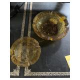 Two amber glass ashtrays