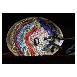Round tray with vintage beaded necklaces