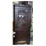 Corner cabinet with wood shelves and glass front