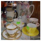 Two porcelain pitchers & four teacup/saucer sets