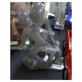 Carved polished stone of loving family embracing,