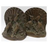 Heavy brass bookends of loving couple